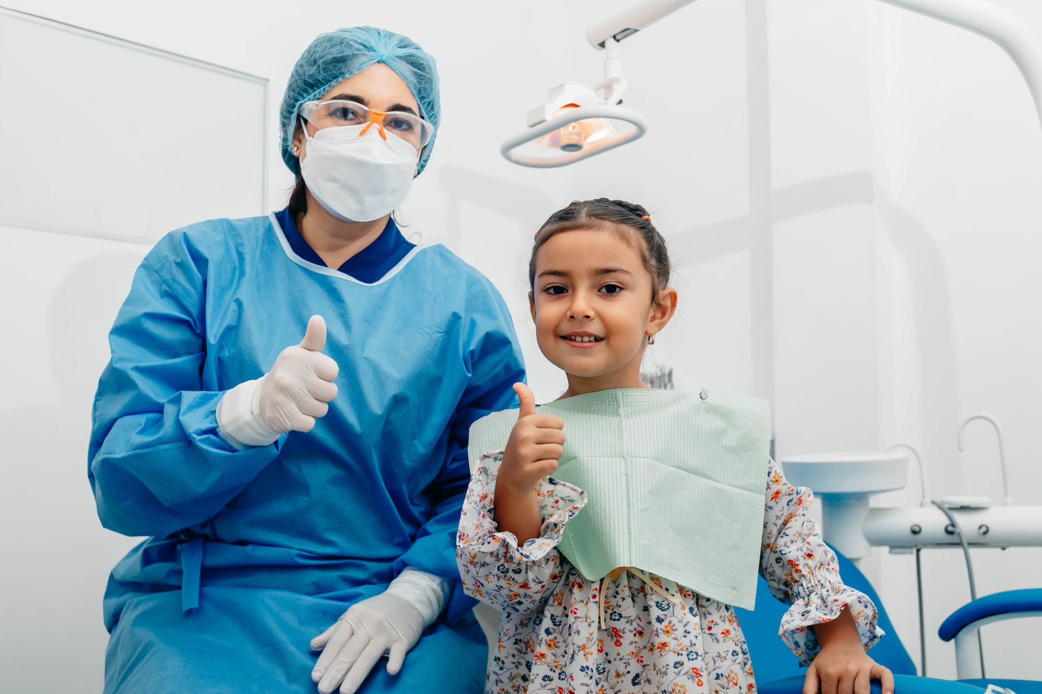 Photo by iam luisao Dentist and Her Patient Posing at the Camera