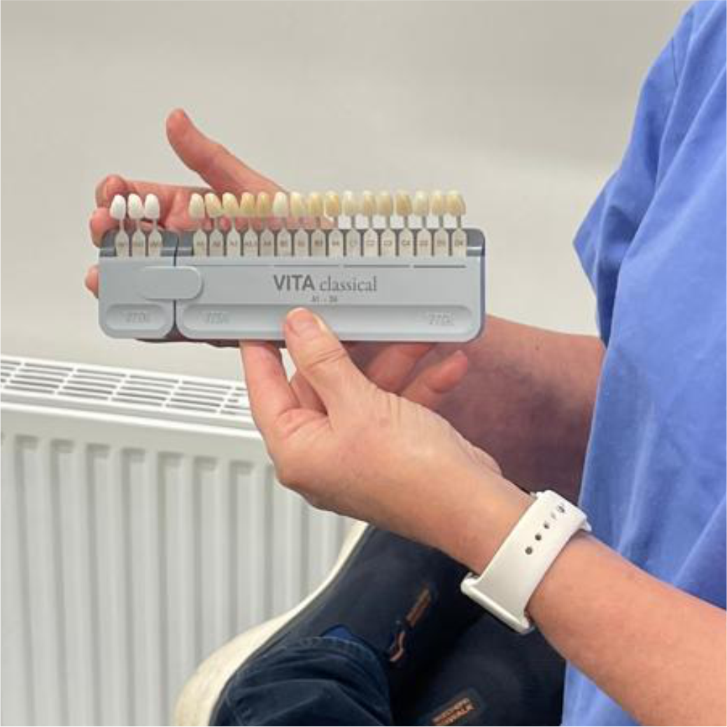 Dentist showing patient a tooth colour guide